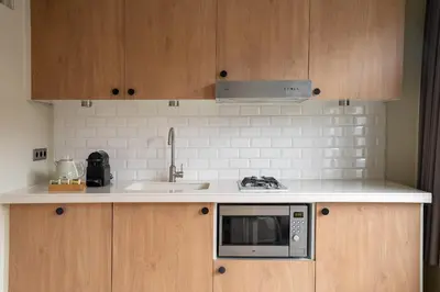 a kitchen with a sink and a microwave at Numa Amsterdam Oosterpark in Amsterdam