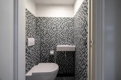a small bathroom with a toilet and a sink at Numa Amsterdam Oosterpark in Amsterdam