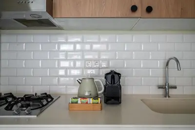 a kitchen counter with a stove and a tea kettle at Numa Amsterdam Oosterpark in Amsterdam