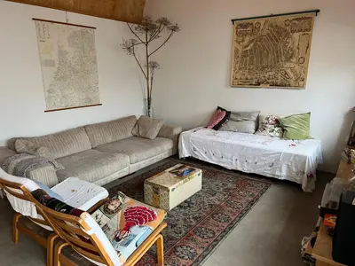 a living room with a couch and a table at Joans B&B in Zaandam