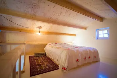 a bedroom with a bed in the attic of a house at Joans B&B in Zaandam
