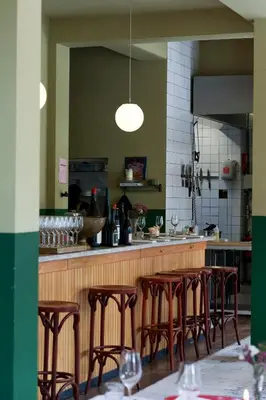 a kitchen with a bar with wooden stools at Cafe Modern in Amsterdam