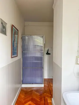 a bathroom with a glass door in a room at Cafe Modern in Amsterdam