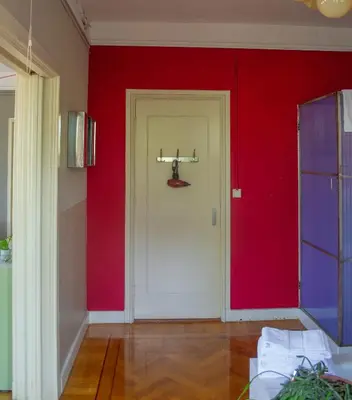 a room with red walls and a white door at Cafe Modern in Amsterdam