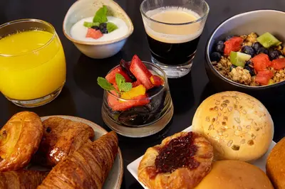a table topped with different types of food and drinks at Boutique Hotel Notting Hill in Amsterdam