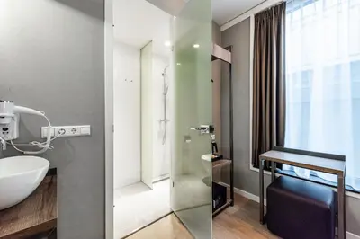 a bathroom with a sink and a shower at Melrose Hotel in Amsterdam