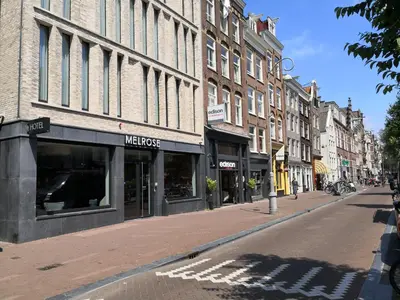 a city street with buildings and a street with a street at Melrose Hotel in Amsterdam