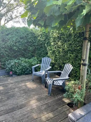 two chairs sitting on top of a wooden deck at chalet hensbroek in Hensbroek