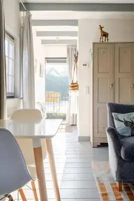 a living room with a table and a chair at The Pool House in Den Dolder