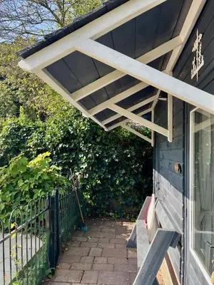 awning on the side of a house with a porch at The Pool House in Den Dolder