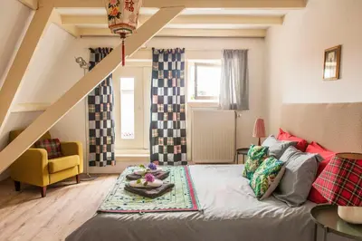 a bedroom with a bed and a staircase in it at The Livingrooms Laren in Laren
