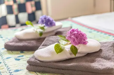 a group of towels with flowers on top of them at The Livingrooms Laren in Laren