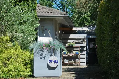 a building with a planter with flowers in it at Casa Batavia B&B in Lelystad