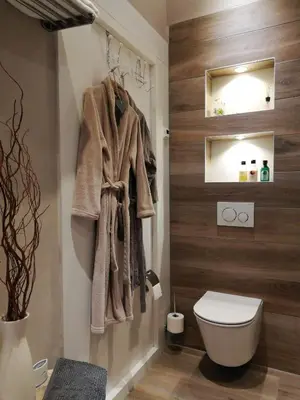 a bathroom with a toilet and a towel rack at Casa Batavia B&B in Lelystad