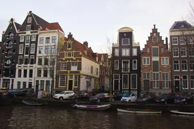a group of buildings next to a canal with boats at Attic Monkeys Lodge in Amsterdam