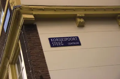 a blue street sign on the side of a building at Attic Monkeys Lodge in Amsterdam
