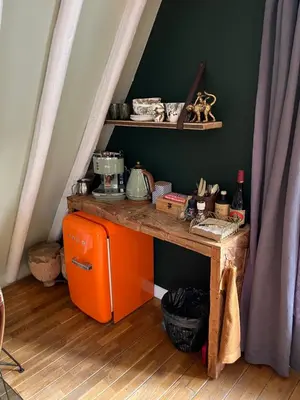 an orange table with a shelf on a wall at Attic Monkeys Lodge in Amsterdam