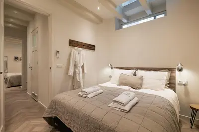 a bedroom with a large bed with two towels on it at Leidse Square 5 star Luxury Apartment in Amsterdam