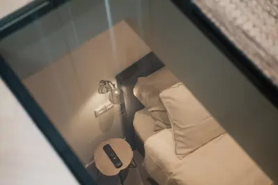 a small room with a bed and a lamp at Leidse Square 5 star Luxury Apartment in Amsterdam