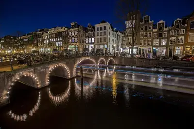 a bridge over a river in a city at night at Leidse Square 5 star Luxury Apartment in Amsterdam