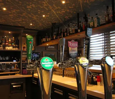 a bar with several parking meters in front of a counter at Best Western Beach Hotel Bergen aan Zee in Bergen aan Zee