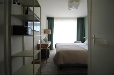 a hotel room with a bed and a window at Best Western Beach Hotel Bergen aan Zee in Bergen aan Zee