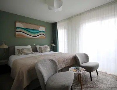 a bedroom with a bed and a table and chairs at Best Western Beach Hotel Bergen aan Zee in Bergen aan Zee