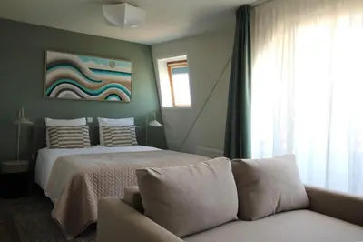 a bedroom with a bed and a couch at Best Western Beach Hotel Bergen aan Zee in Bergen aan Zee