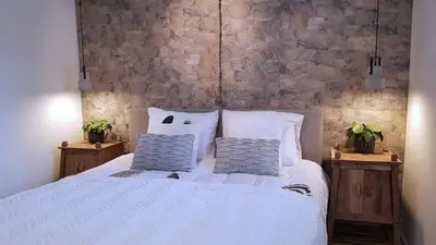 a bedroom with a white bed with two pillows at INTIKA Beach House in Zandvoort