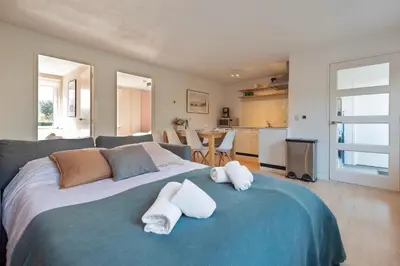 a bedroom with a large bed with towels on it at Spacious Family Holiday Home (7p), Free indoor parking in Zandvoort