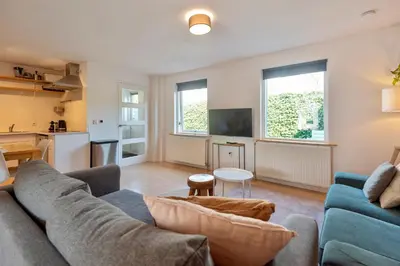 a living room with a couch and a table at Spacious Family Holiday Home (7p), Free indoor parking in Zandvoort