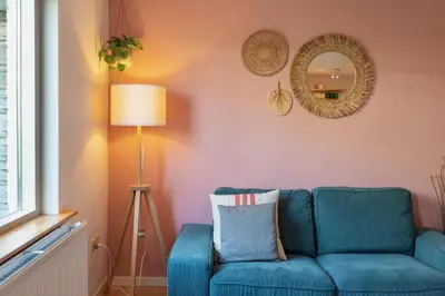a living room with a blue couch and a lamp at Spacious Family Holiday Home (7p), Free indoor parking in Zandvoort