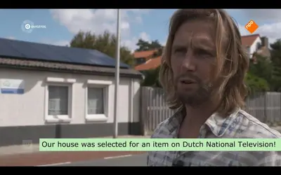 a man in front of a house with his eyes closed at Spacious Family Holiday Home (7p), Free indoor parking in Zandvoort