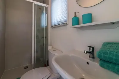 a bathroom with a toilet and a sink and a shower at CHALETS IN THE DUNES nearby the beach in IJmuiden