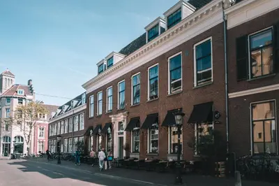 a brick building on a street with people walking on the sidewalk at Anne&Max Boutique Hotel in Utrecht