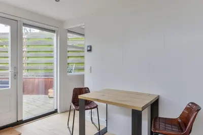 a dining room with a table and chairs at Modern Bungalow Zandvoortselaan in Zandvoort