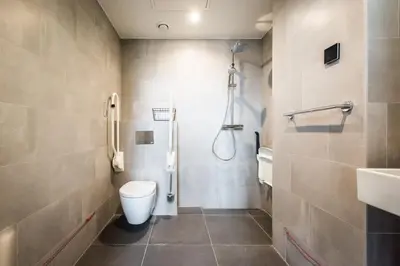 a bathroom with a toilet and a shower and a sink at YAYS Amsterdam East by Numa in Amsterdam