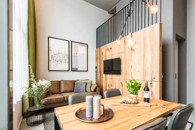 a dining room with a table and a couch at YAYS Amsterdam East by Numa in Amsterdam