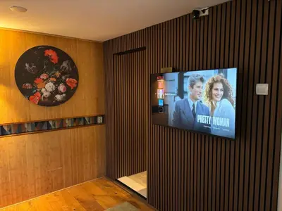a flat screen tv on a wall in a room at Houseboat Amsterdam in Amsterdam