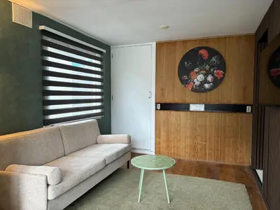a living room with a couch and a table at Houseboat Amsterdam in Amsterdam