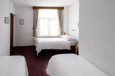 a room with two beds and a window at Hotel Ben Centre in Amsterdam