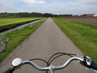 a bike parked on a road next to a field at Boutique Suites Lisse - Keukenhof in Lisse