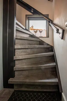 a set of stairs in a room with a window at La Chatelaine in Egmond aan Zee