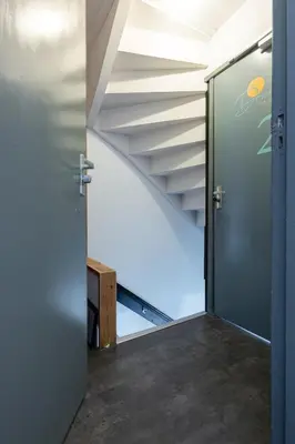 an open door leading to a staircase in a house at La Chatelaine in Egmond aan Zee