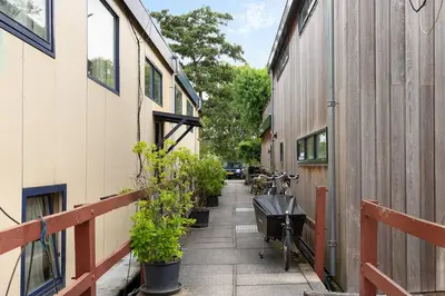 a bike parked on a sidewalk next to a building at Authentic Dutch Houseboat in Amsterdam Zuid in Amsterdam