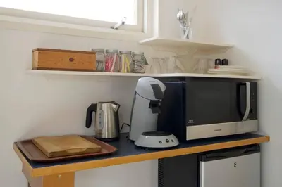a kitchen counter with a microwave and a blender at Authentic Dutch Houseboat in Amsterdam Zuid in Amsterdam
