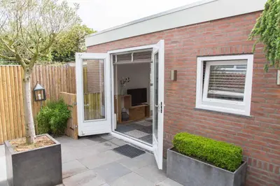 a brick house with a door and a window at B&B Bike Studio Amsterdam in Amsterdam