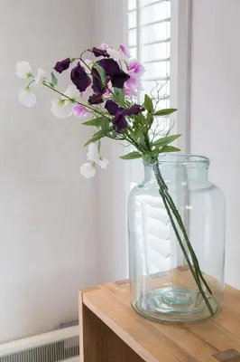 a vase filled with purple and white flowers on a table at B&B Bike Studio Amsterdam in Amsterdam