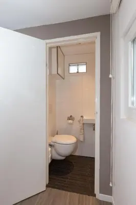 a bathroom with a white toilet and a sink at B&B Bike Studio Amsterdam in Amsterdam