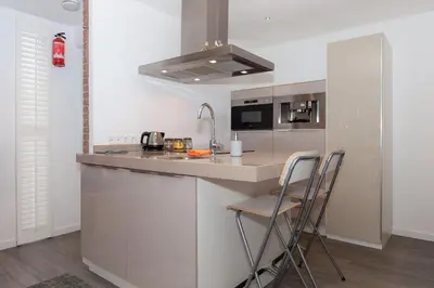 a kitchen with a counter and two stools in it at B&B Bike Studio Amsterdam in Amsterdam